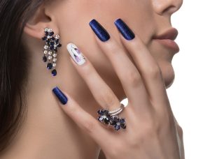 woman-with-nail-art-promoting-design-luxury-earrings-ring-1-1.jpg